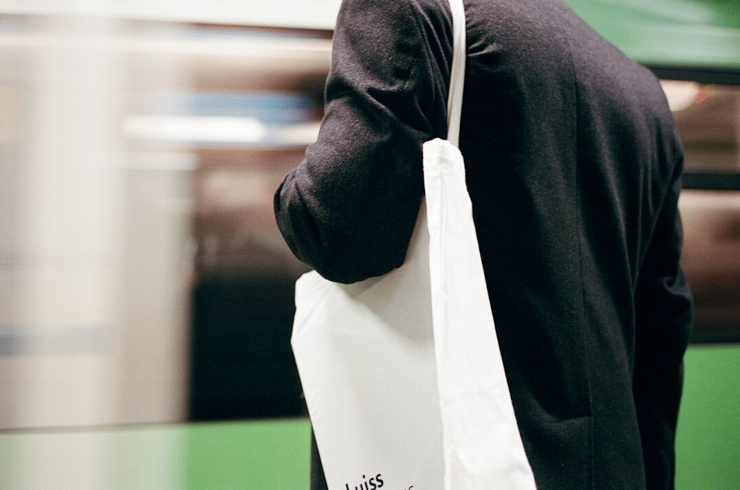 person hiding item in bag